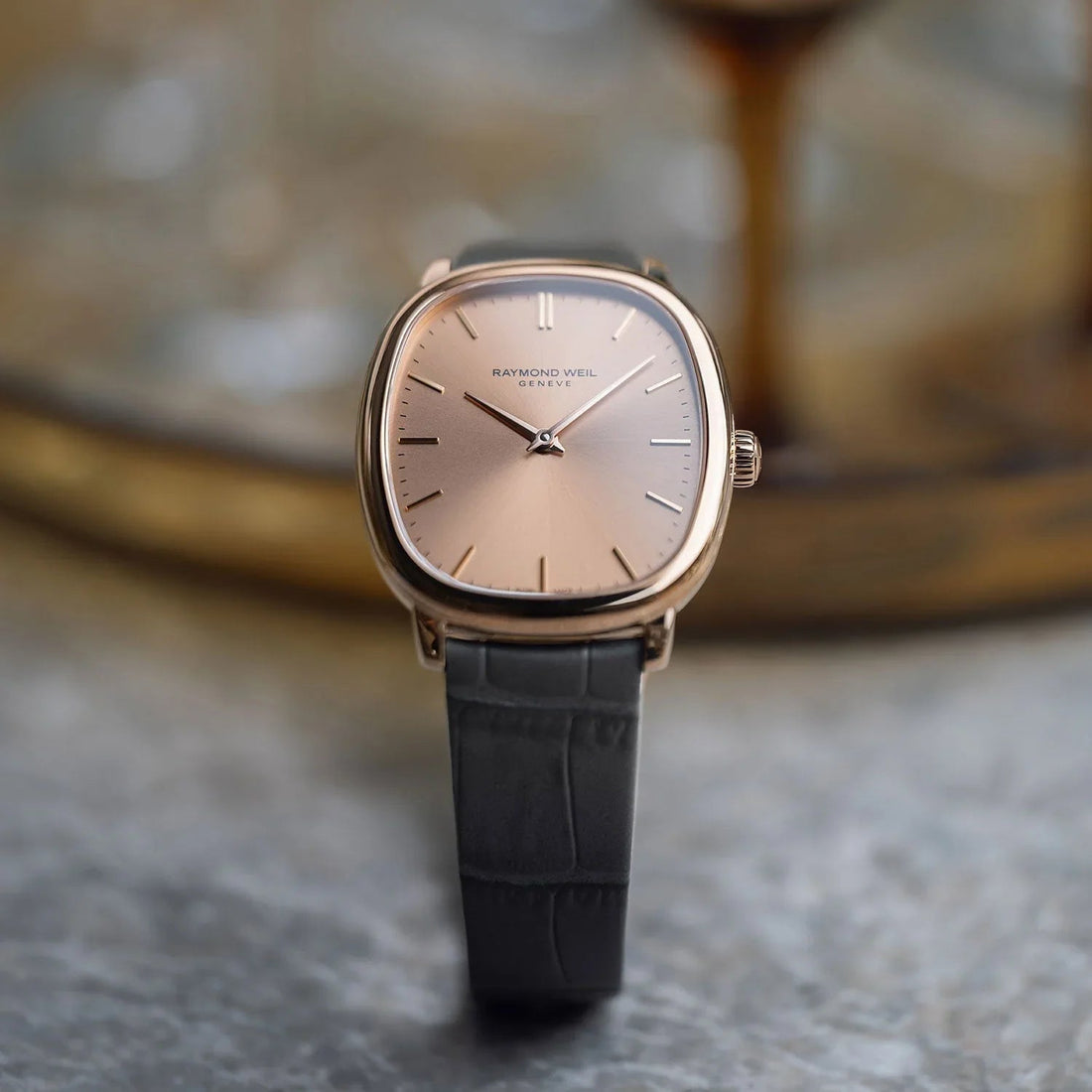 RAYMOND WEIL rose gold-tone watch with black leather strap and classic design