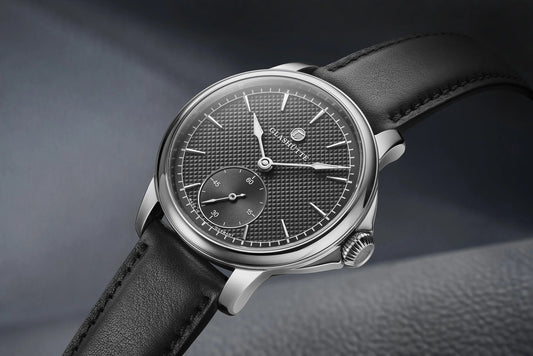 Luxury mechanical wristwatch with textured black dial, subdial, and black leather strap on display